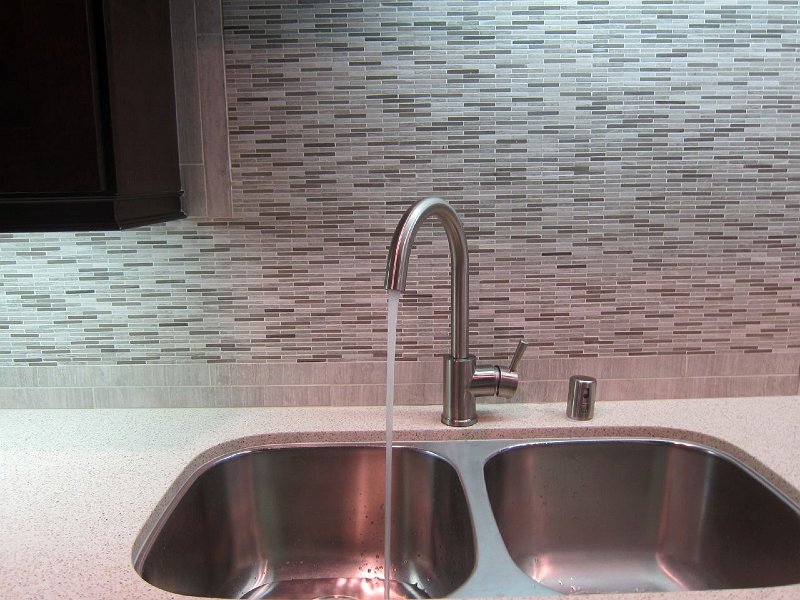 Kitchen sink with marble tile back spash